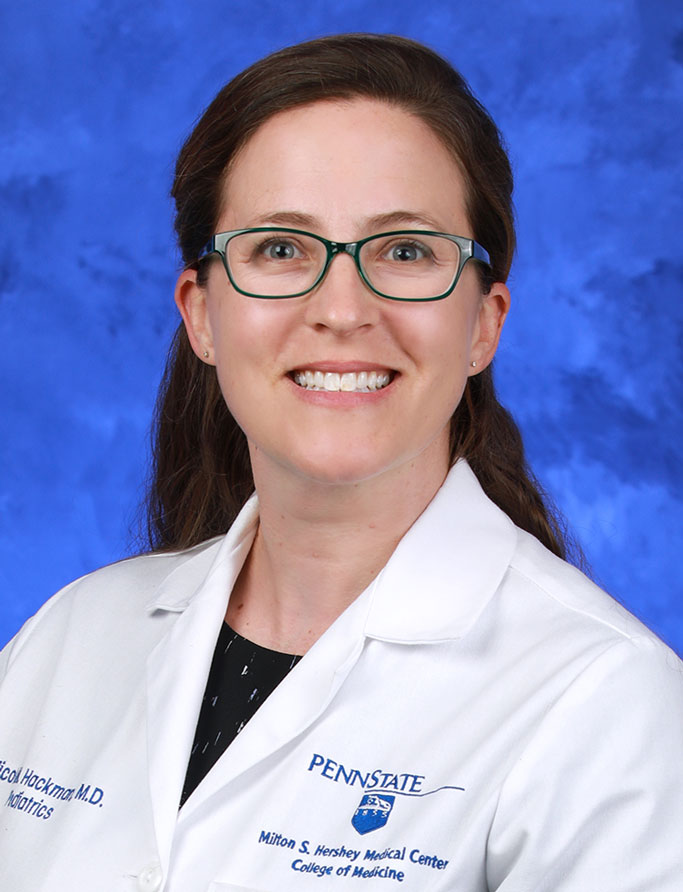 A photo of Nicole Hackman, MD, in her white lab coat