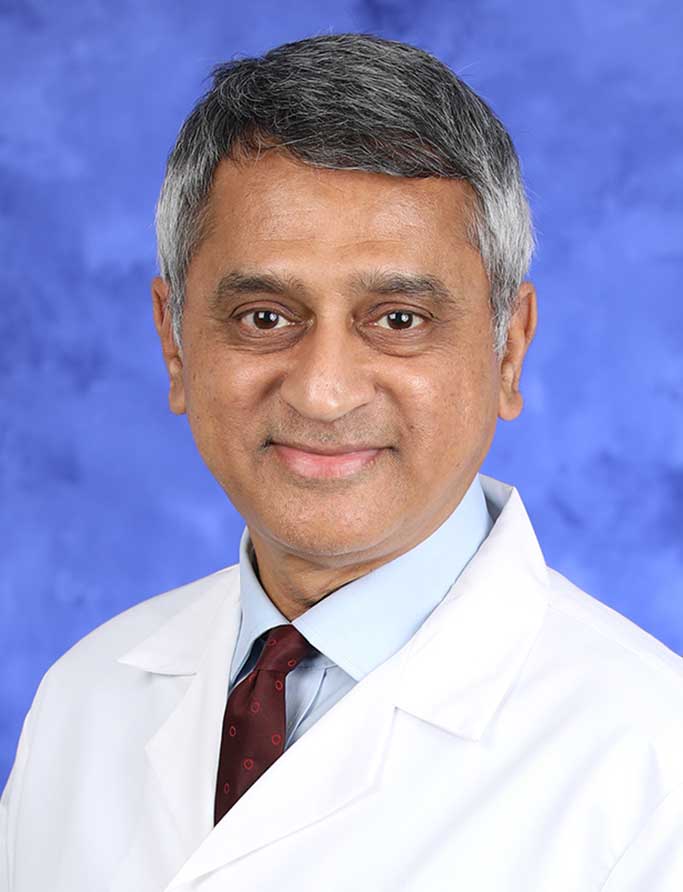 Yatin Vyas, MD, is Chair of the Department of Pediatrics at Penn State College of Medicine. He is pictured in a medical coat against a professional photo background.